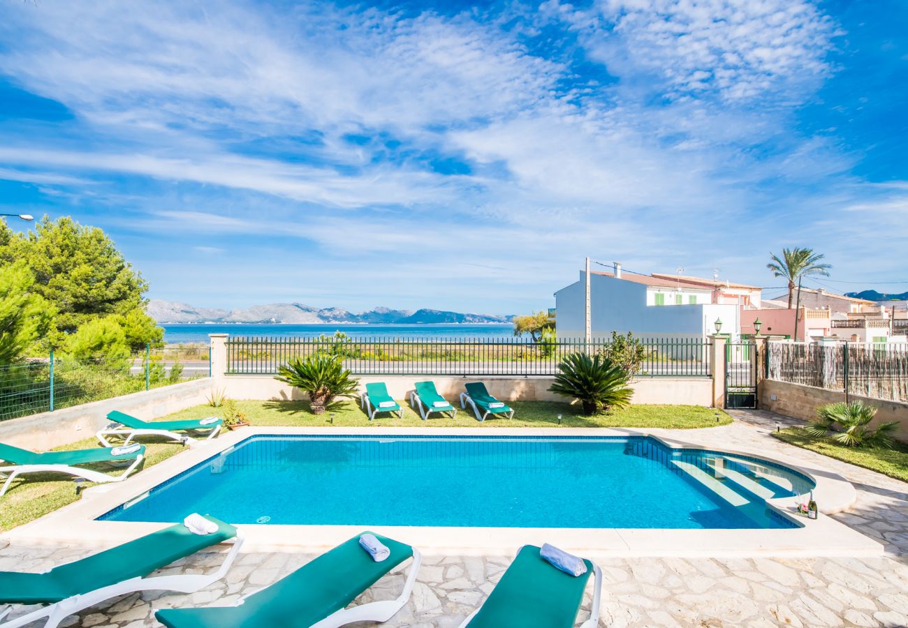 House with pool in front of the sea.